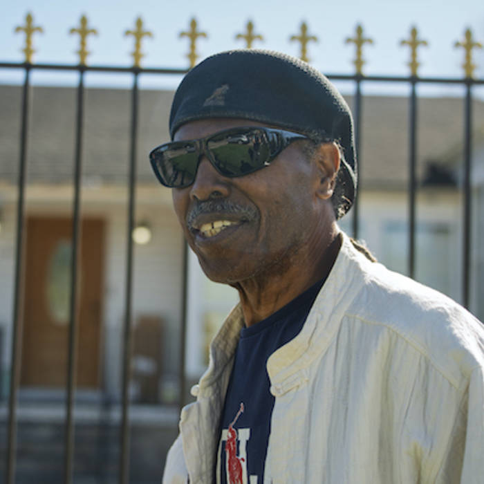 Abe Thompson outdoors in New Orleans, wearing sunglasses and a black cap